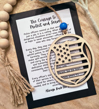 Load image into Gallery viewer, Wooden police badge shaped ornament with American flag details and an appreciation message card honoring their service to the community and reminding us to Back the Blue.