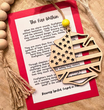 Load image into Gallery viewer, Wooden ornament shaped like a firefighter Maltese cross with an American flag design with bravery appreciation message card.