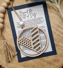 Load image into Gallery viewer, Wooden veteran charm ornament with American flag details with keepsake story card honoring sacrifice, bravery and dedication to protecting freedom of the United States.