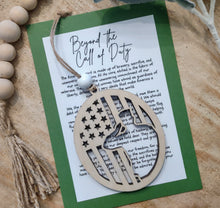 Load image into Gallery viewer, Wooden soldier saluting veteran charm ornament with American flag details and keepsake story card honoring sacrifice, bravery and dedication to protecting freedom of the United States.