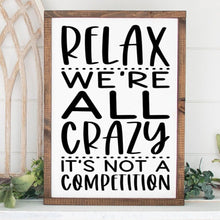 Load image into Gallery viewer, Relax we're all crazy it's not a competition handmade painted wood sign.