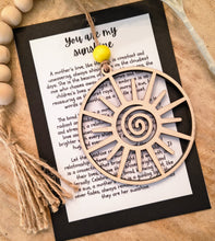 Load image into Gallery viewer, A wooden charm ornament in the shape of a sun with a heartfelt keepsake card highlighting the bond between a mother and child.
