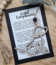 Load image into Gallery viewer, A wooden ornament shaped like the silhouette of a dog with a keepsake card that honors the loyalty and companionship we enjoy with dogs.
