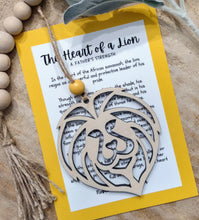 Load image into Gallery viewer, Wooden lion head shaped charm ornament with an inspirational message card honoring the love and protective strength of fathers.
